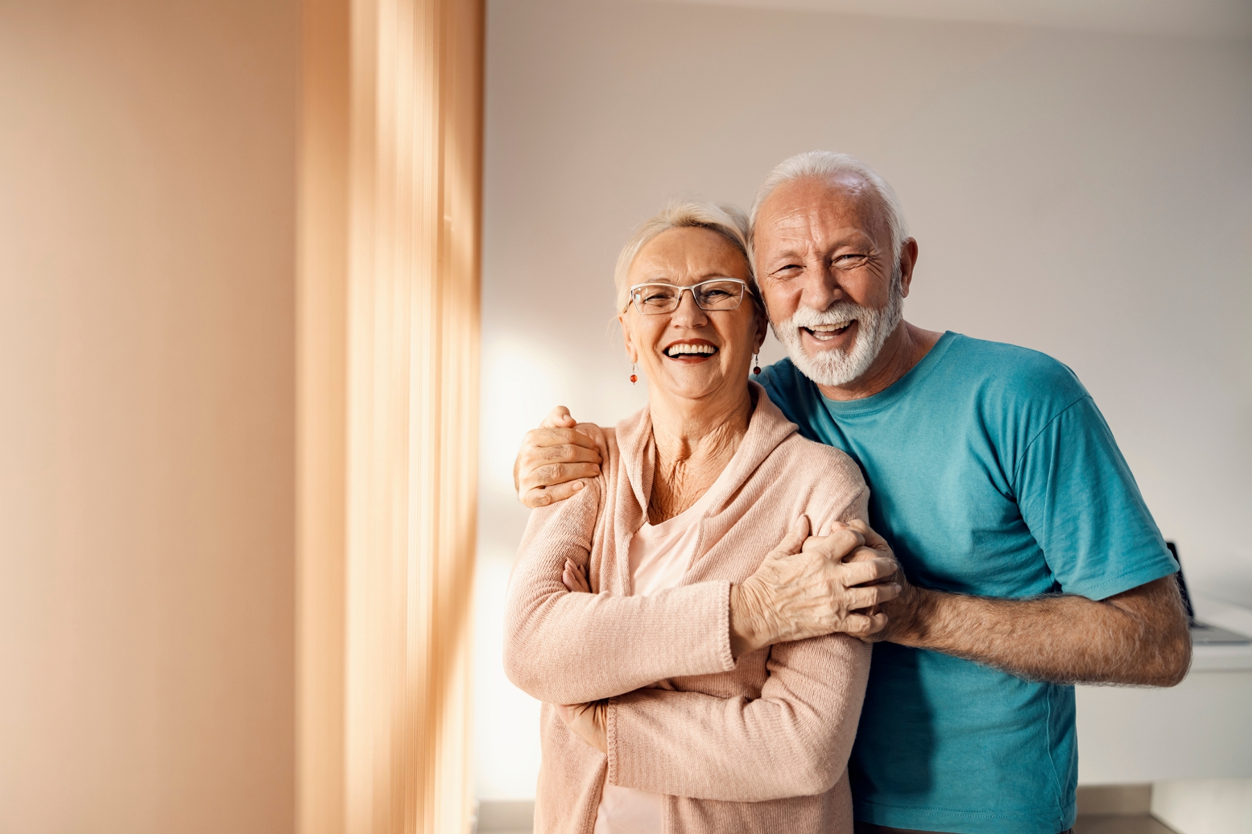 Smiling older couple representing confidence after cosmetic dental care
