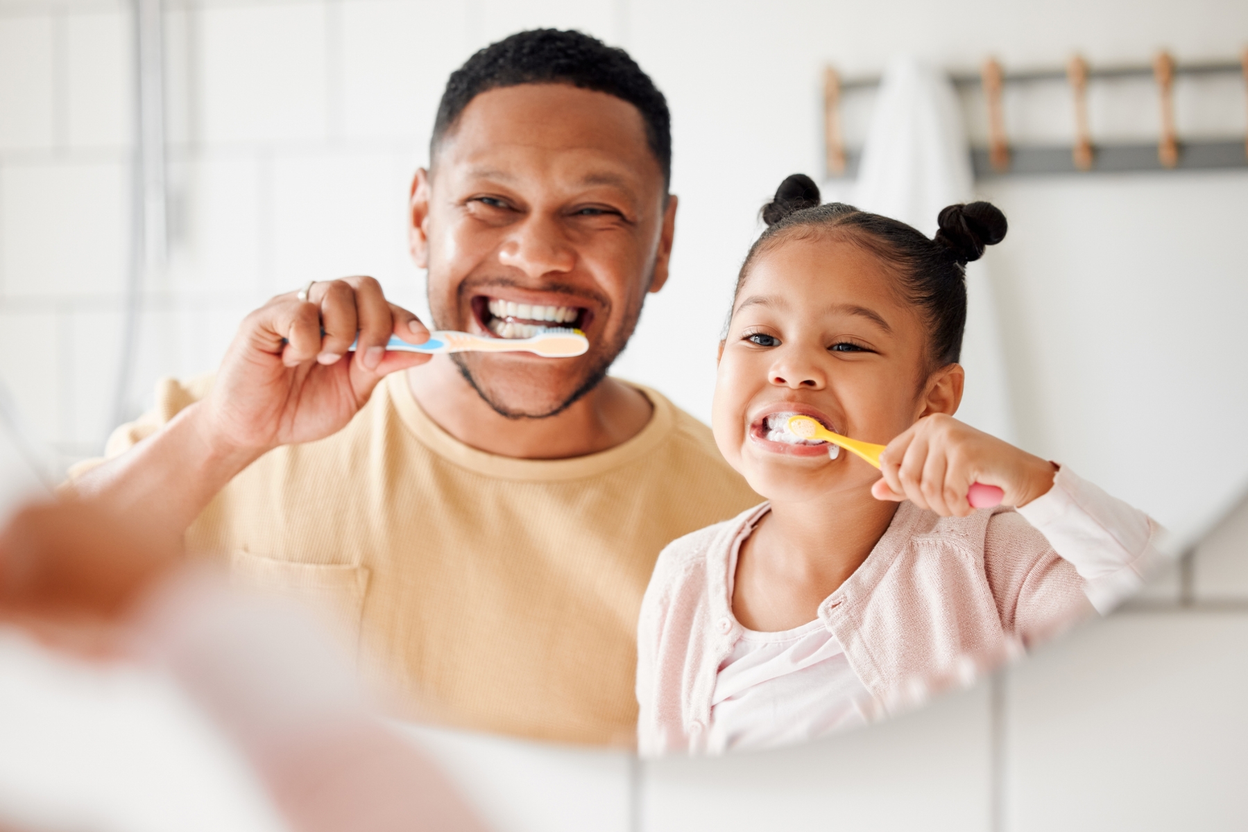 father and daughter brushing their teeth in high point, nc