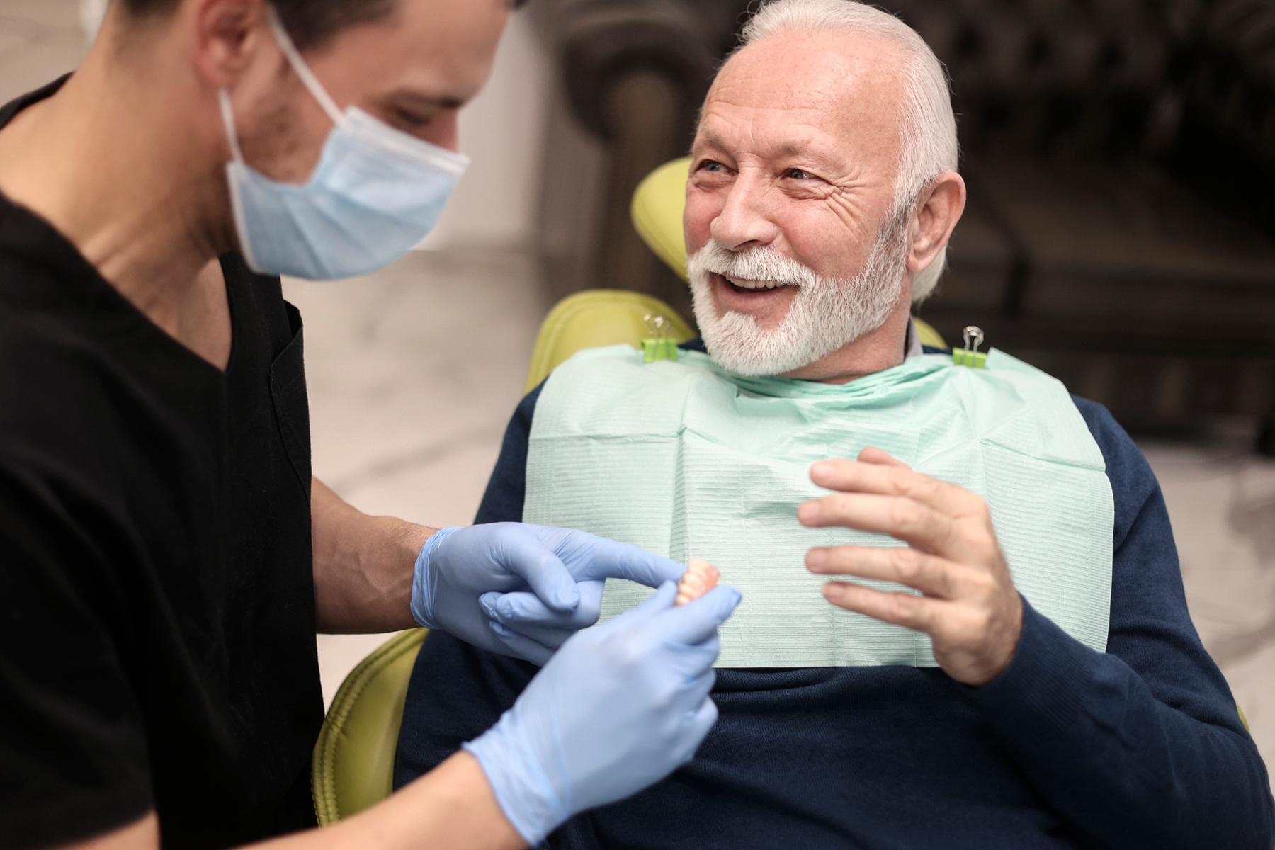 Dentist discussing denture options with an older patient