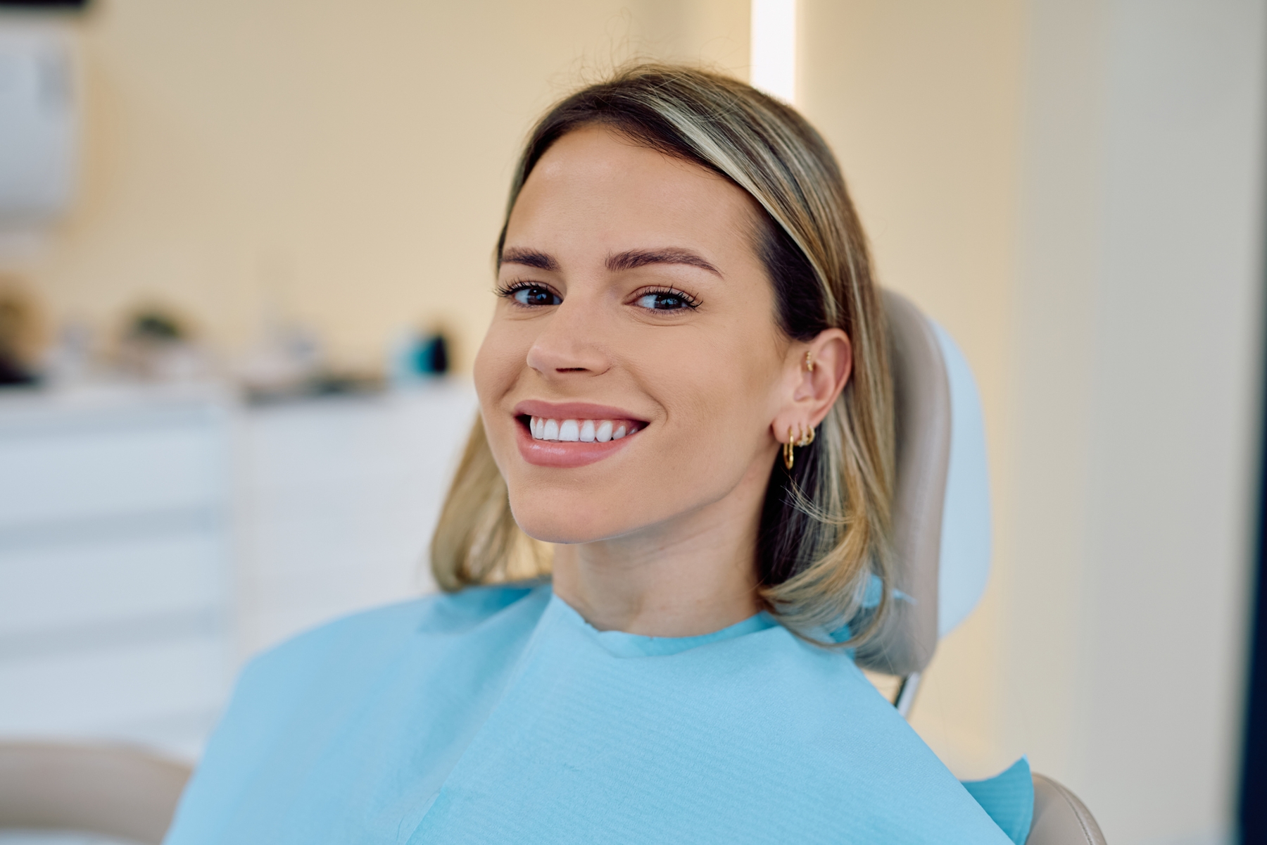Smiling patient in a dental chair, representing full mouth reconstruction care