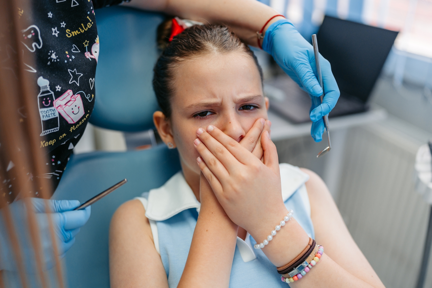 Anxious child during a dental visit, representing dental anxiety