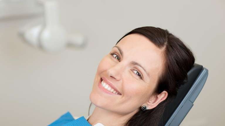 A lady smiling after check up in High Point, NC